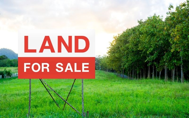 land for sale sign on empty land
