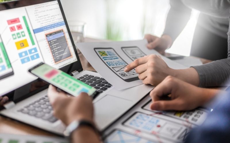 designers drawing website ux app development