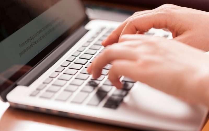 female hands working on data entry with keyboard