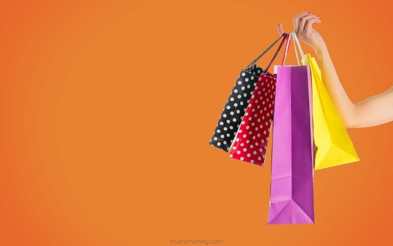A hand carrying paper bags_Ways to Make Extra Money in the UK