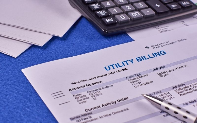utility billing sheet, calculator, pen and envelopes