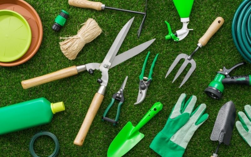 gardening tools and utensils on a lush green meadow