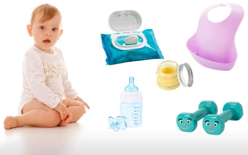 Photo showing a baby sitting, a wet wipes pack, baby feeding bottle, plastic bib, toy dumbbell and a balm for baby